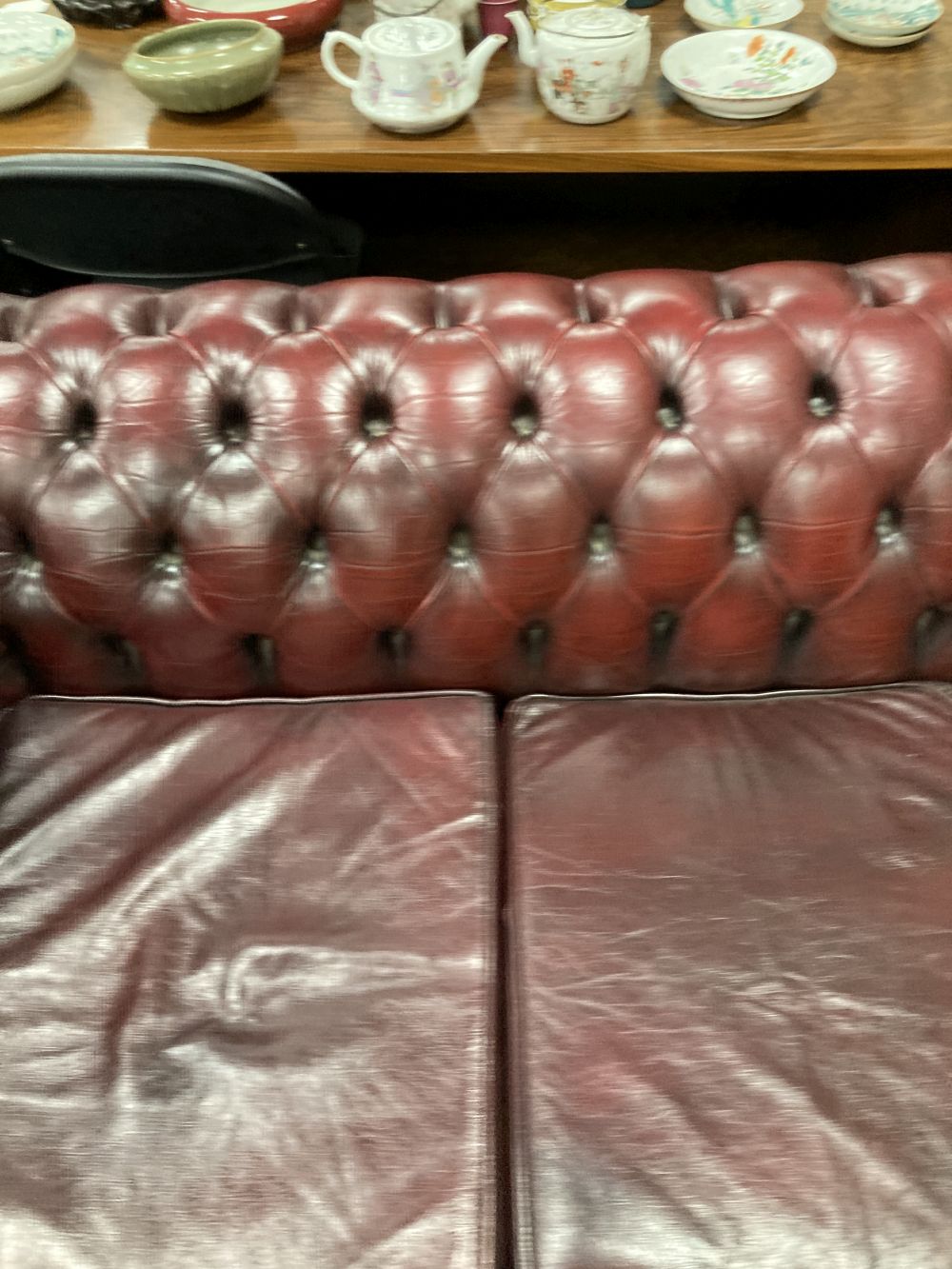 A Victorian style buttoned burgundy leather three seater Chesterfield settee, width 190cm depth 85cm height 72cm